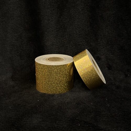 Roll of Gold Glitter hula hoop tape on a black background
